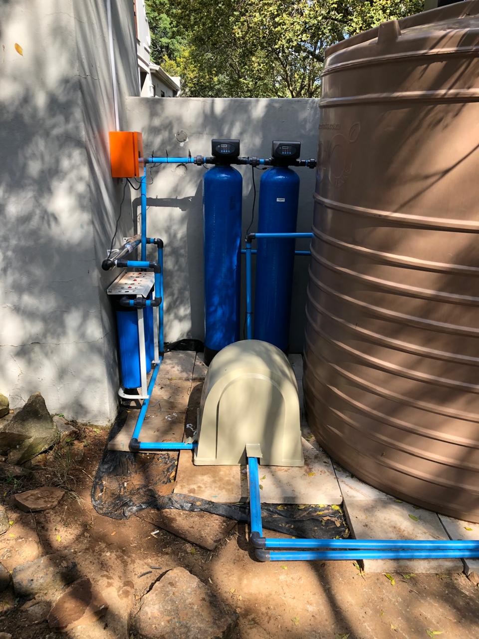 Water filtration and treatment system with storage tank